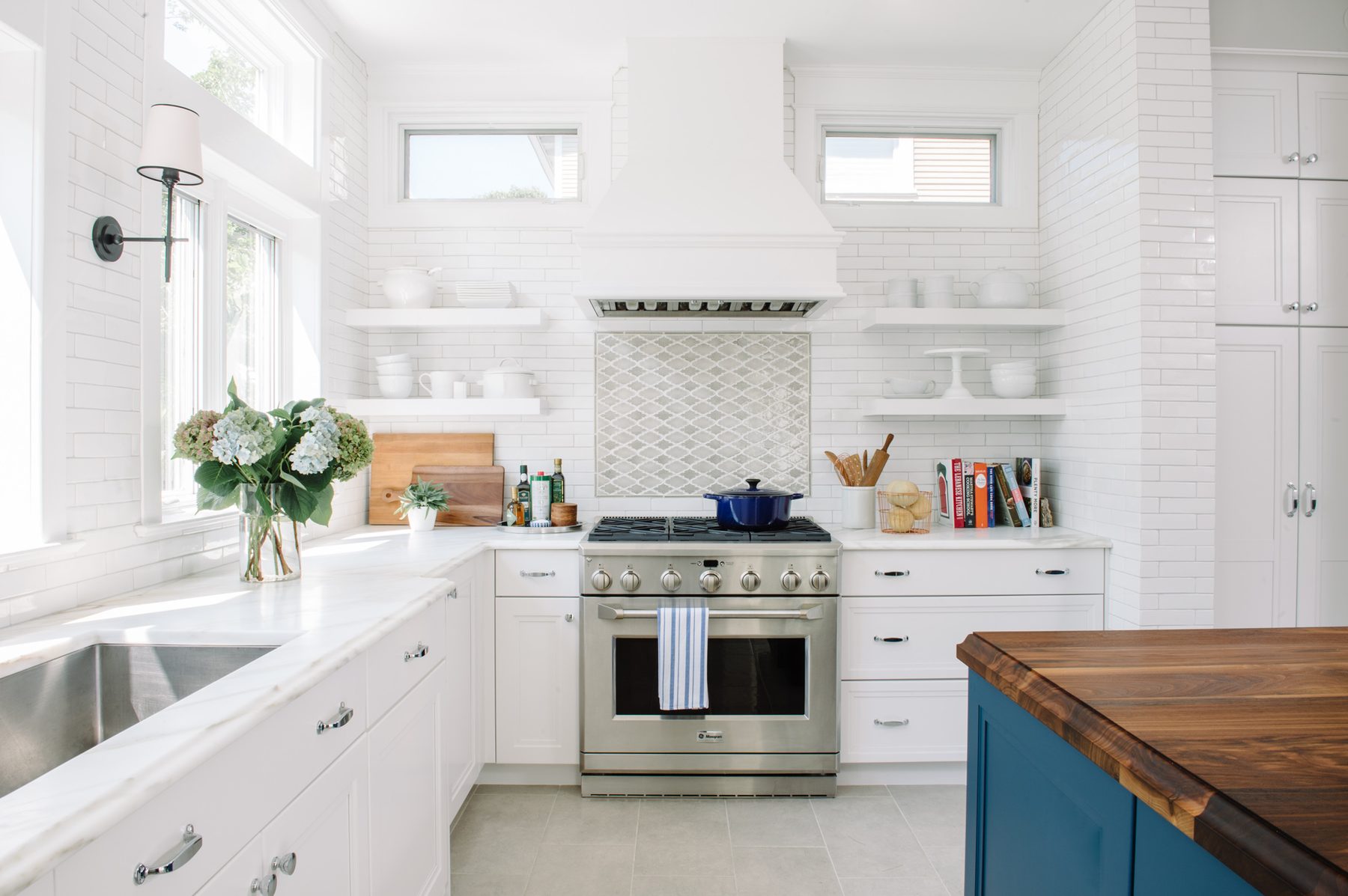 White kitchen with Blue Lagoon navy island and unlacquered brass — the Southern Living kitchen by Christopher Patrick Interiors, Washington, DC
