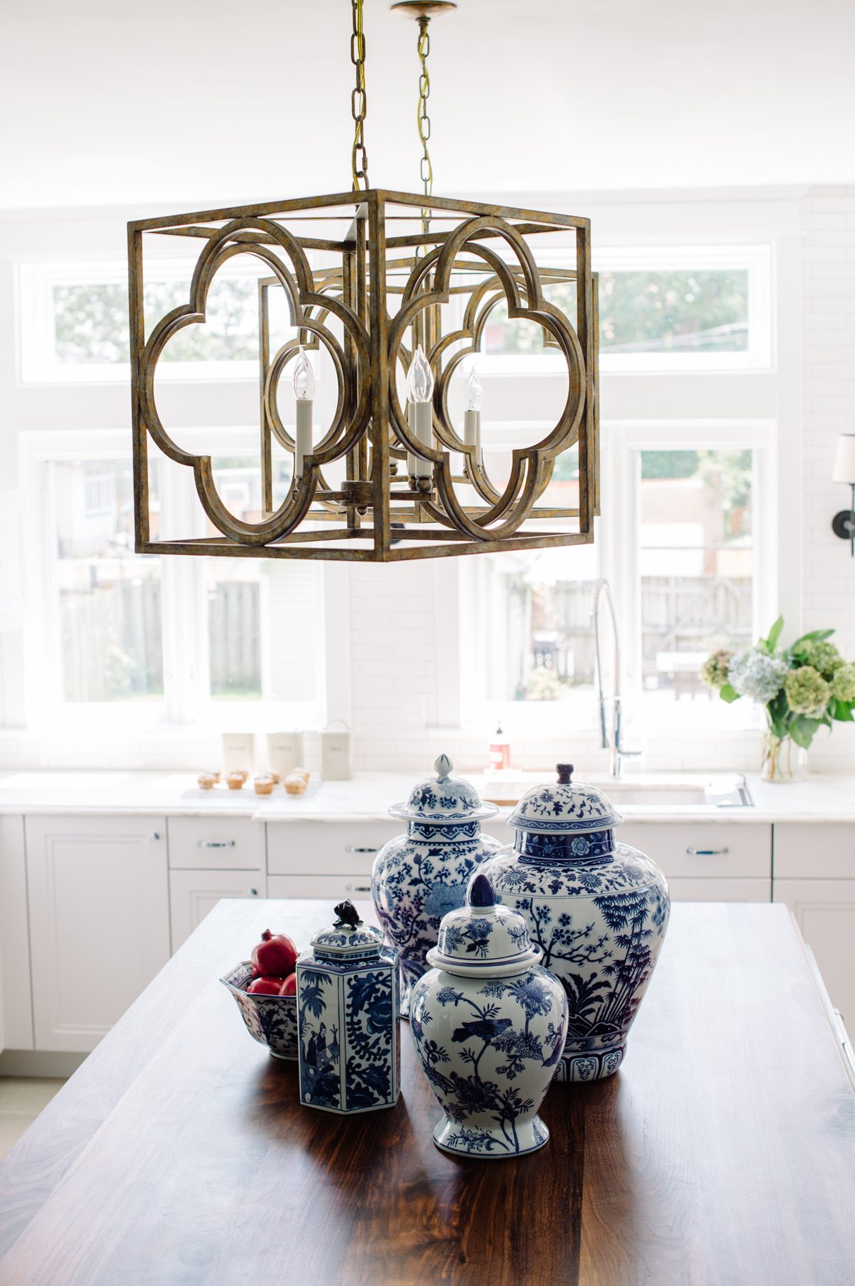 White kitchen with Blue Lagoon navy island and unlacquered brass — the Southern Living kitchen by Christopher Patrick Interiors, Washington, DC